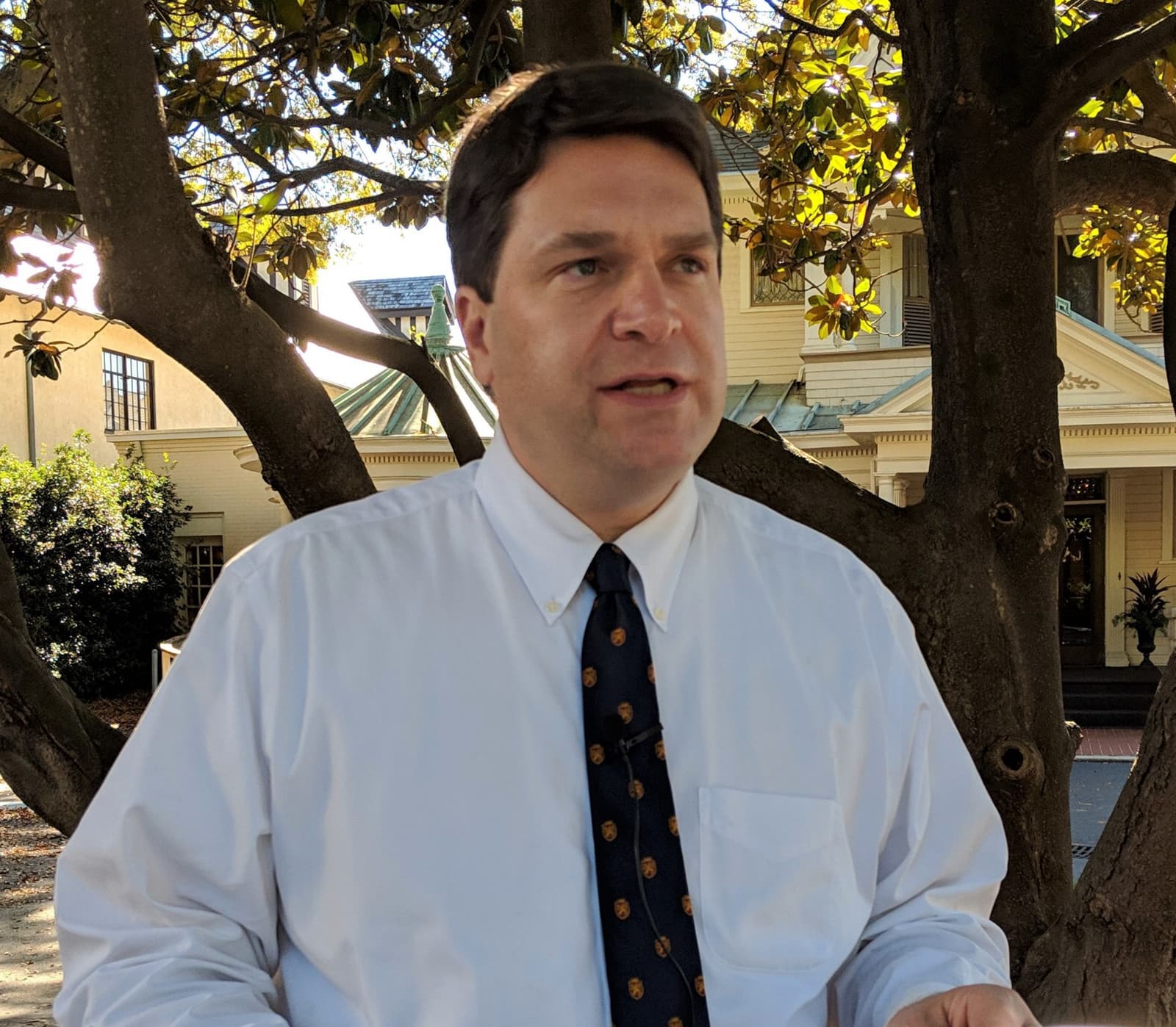 Max T. Hyde, Jr. of Hyde Law Firm, P.A., in conversation outdoors in downtown Spartanburg, SC, papers in hand